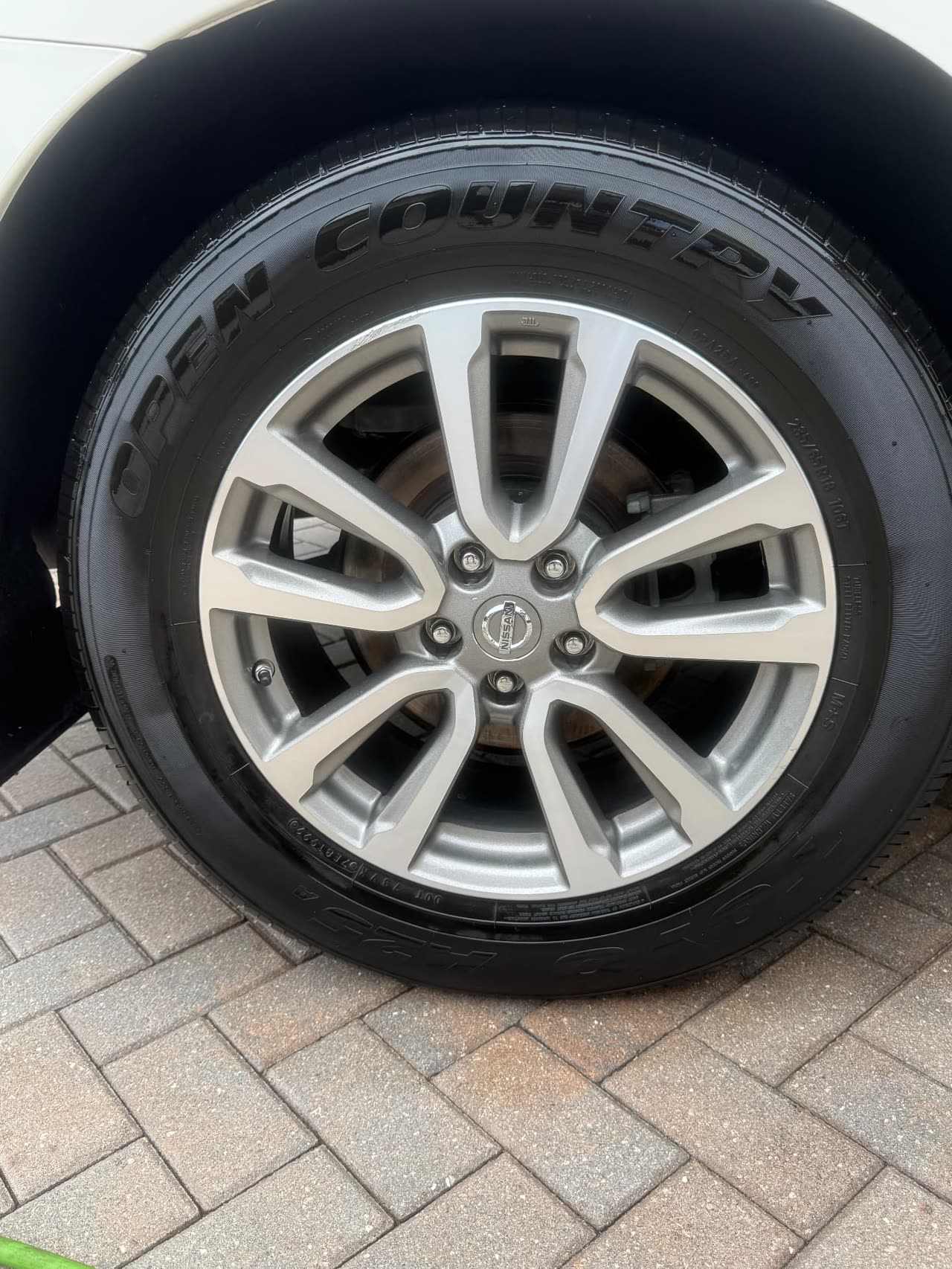 Same wheel after deep cleaning and tire dressing by Obsidian Auto Spa